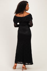 woman wearing a black off-the-shoulder lace gown with long sleeves and a fitted silhouette, viewed from the back