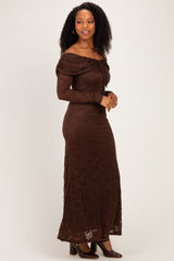 woman wearing a brown off-the-shoulder lace maxi dress with a fitted silhouette and long sleeves
