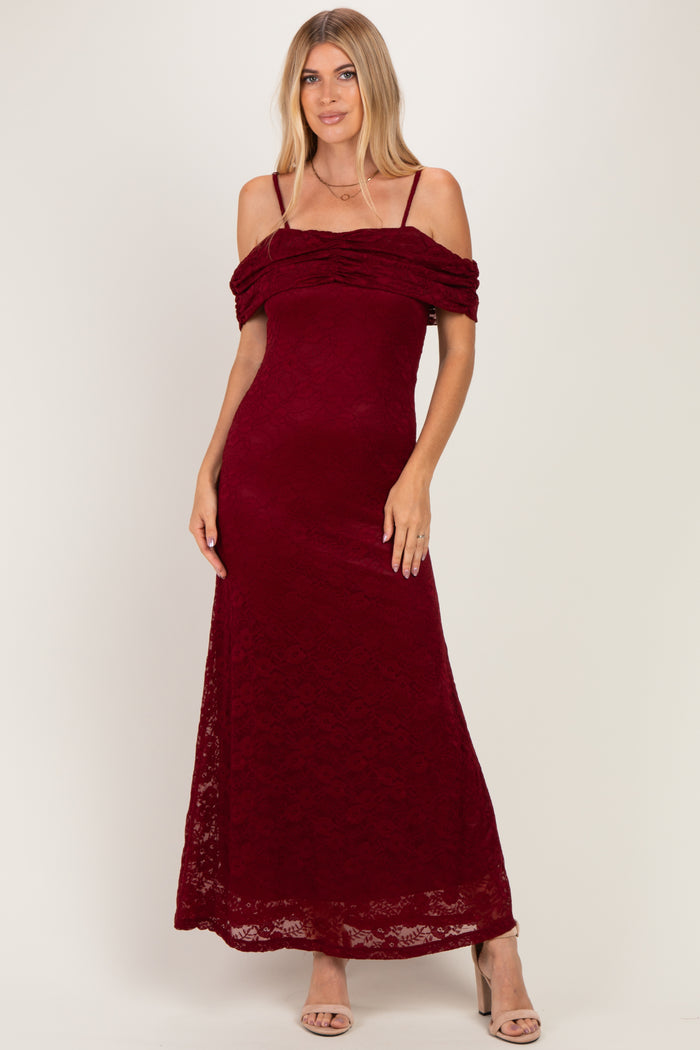 woman wearing a burgundy off-the-shoulder lace maxi dress with ruching detail and thin straps