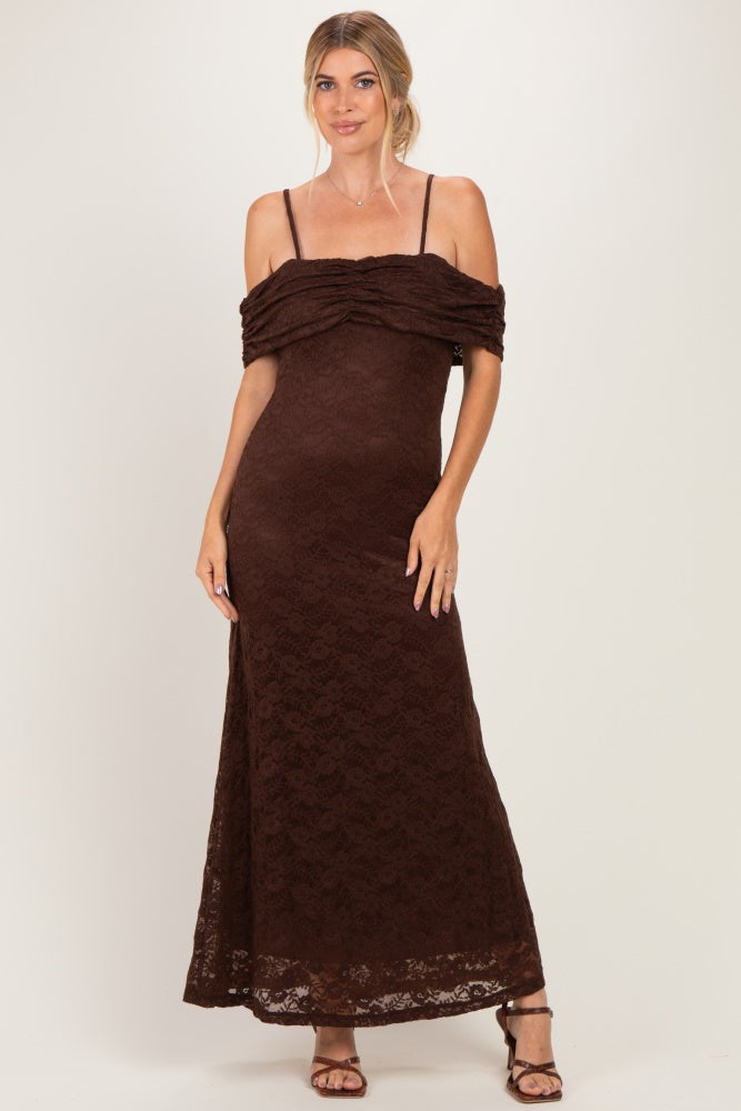 woman wearing a brown lace maxi dress with off-the-shoulder sleeves and a fitted silhouette