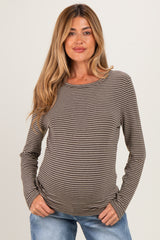 woman wearing a brown and cream striped maternity top with long sleeves and a relaxed fit, showing her baby bump