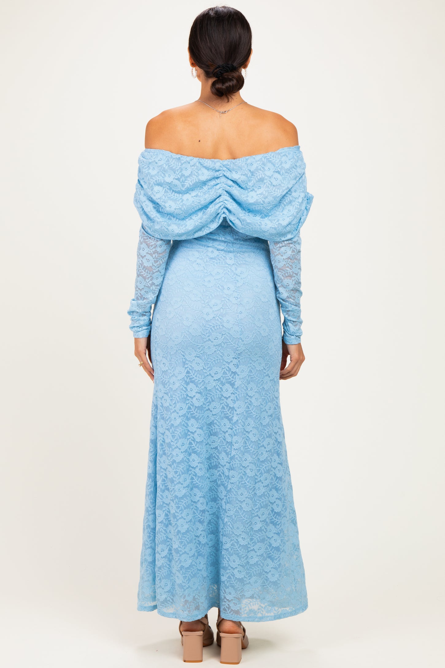 woman wearing a back view of a light blue off-the-shoulder lace maxi dress