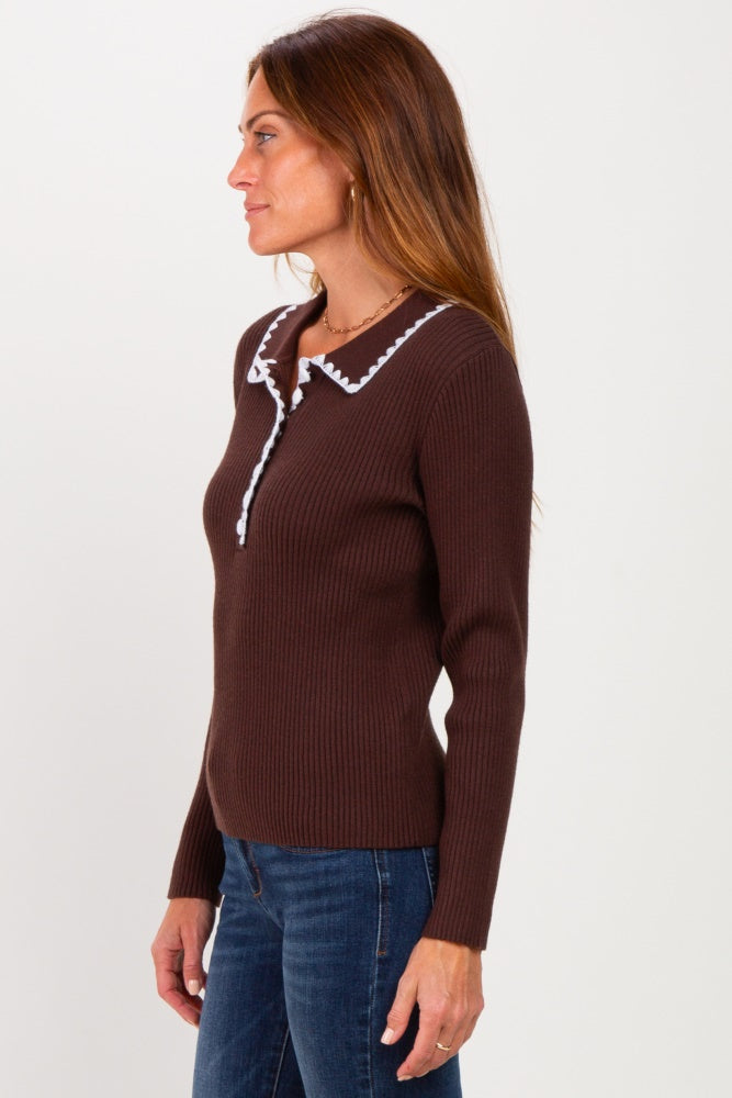 woman wearing a brown ribbed long sleeve top with a white collar detail and button closure, styled with blue jeans