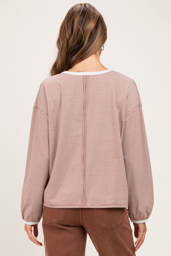 woman wearing a mauve striped maternity top with balloon sleeves and a relaxed fit, shown from the back