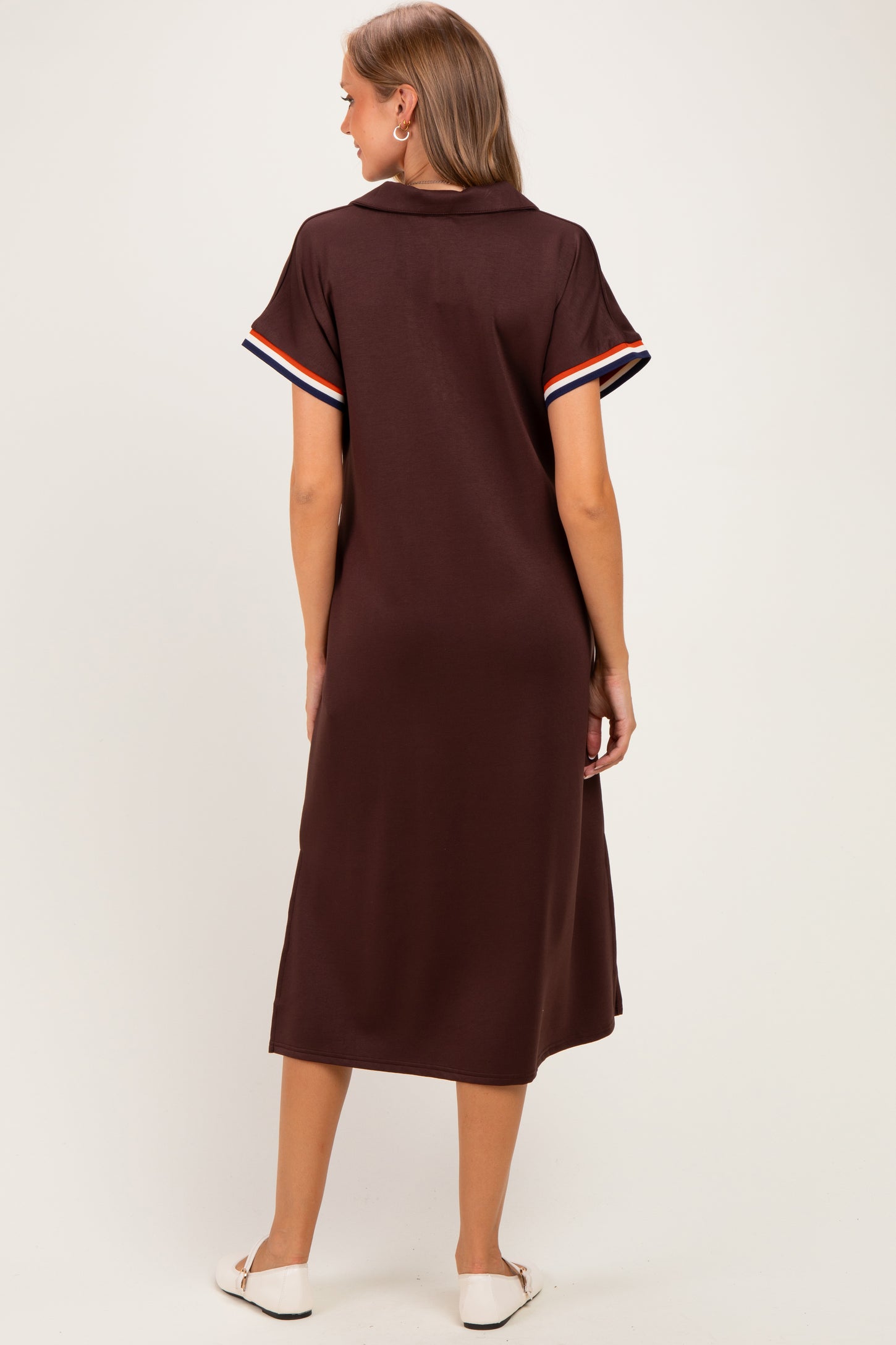 woman wearing a brown maternity polo dress with striped short sleeves, viewed from the back