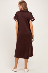 woman wearing a brown maternity polo dress with striped short sleeves, viewed from the back