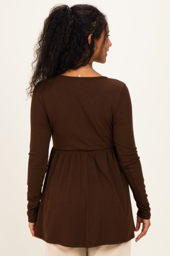 woman wearing a brown long sleeve maternity top with a peplum style and a relaxed fit from the back