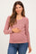 woman wearing a red and white striped maternity top with button details and holding her baby bump