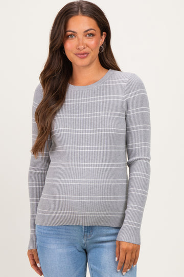 woman wearing a light gray maternity sweater with horizontal stripes and long sleeves, smiling at the camera