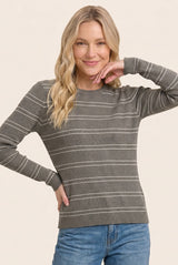 woman wearing a gray striped long sleeve sweater with a crew neckline and a relaxed fit