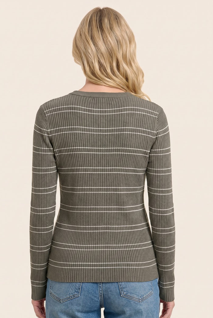woman wearing a green ribbed long sleeve top with white stripes, seen from the back