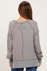 woman wearing a gray ribbed oversized sweatshirt with a back seam detail and drop shoulder sleeves