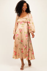 woman wearing a floral print maxi dress in soft beige with puff sleeves and a fitted bodice