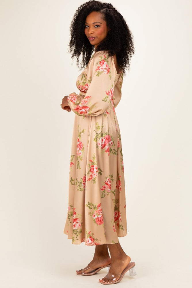woman wearing a beige floral midi dress with long sleeves and a flowy silhouette