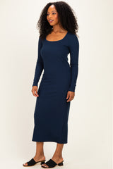 woman wearing a navy long sleeve ribbed maxi dress and black slide sandals