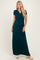 woman wearing a dark green short sleeve maxi dress with a twist front detail and standing in neutral sandals
