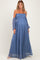 woman wearing a blue off-shoulder maternity dress with long sleeves and smocked bodice, showing a baby bump