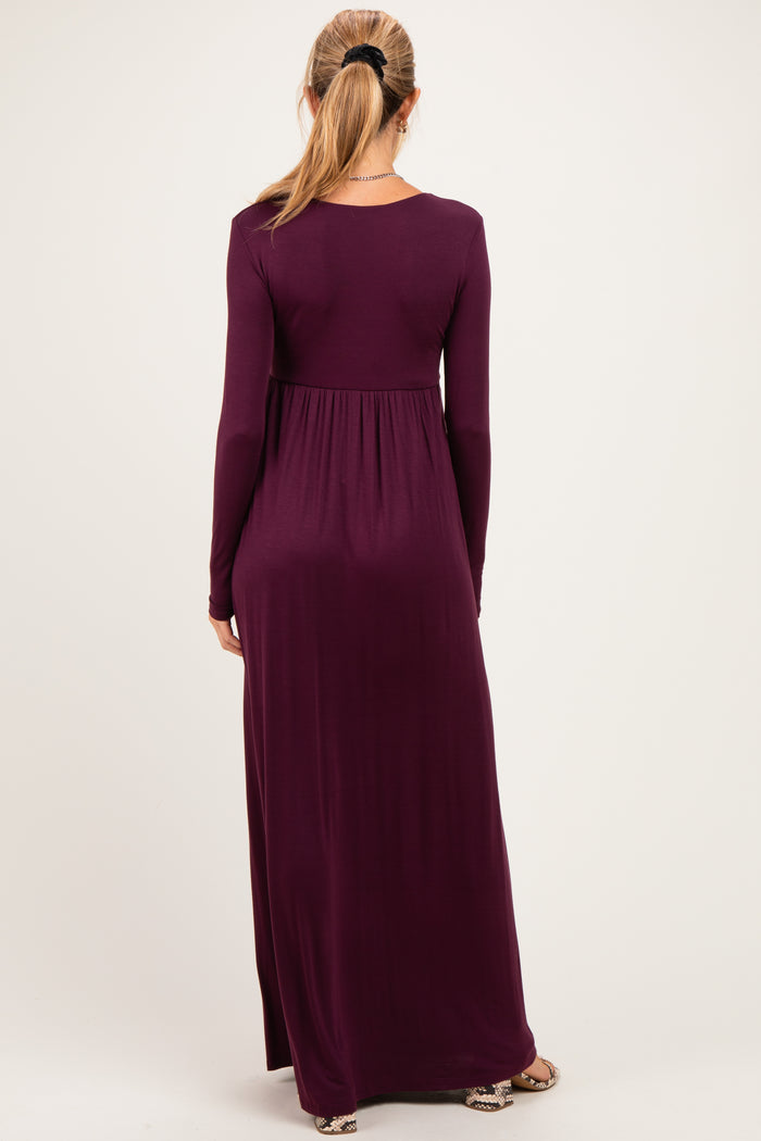 woman wearing a long sleeve purple maternity maxi dress with a flowy bottom and a relaxed fit, showing her baby bump
