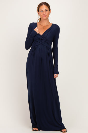 woman wearing a navy blue long sleeve wrap maxi dress with a twisted bodice design