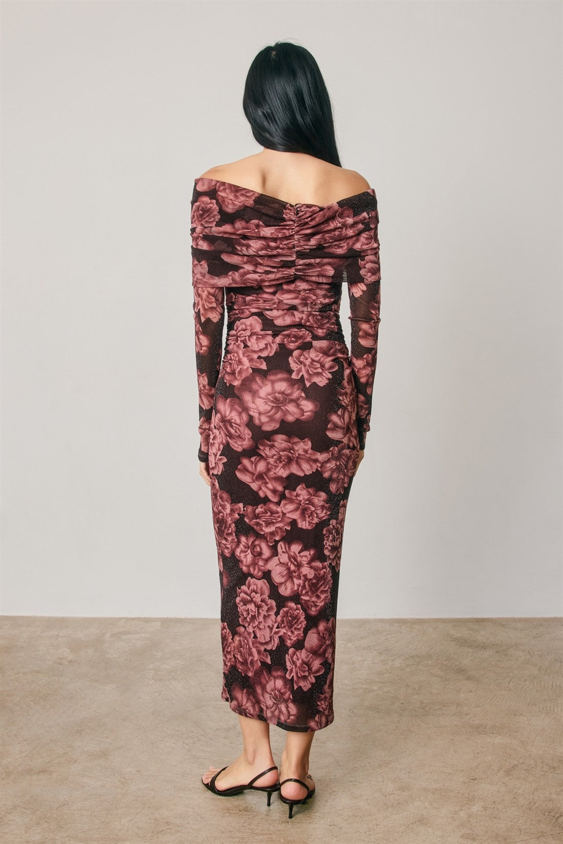 woman wearing a long sleeve off-the-shoulder floral print midi dress in burgundy and pink