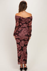woman wearing a burgundy floral off-shoulder maternity dress, showing a baby bump from the back