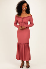 woman wearing a dusty rose off-the-shoulder ribbed maxi dress with ruffled hem and long sleeves