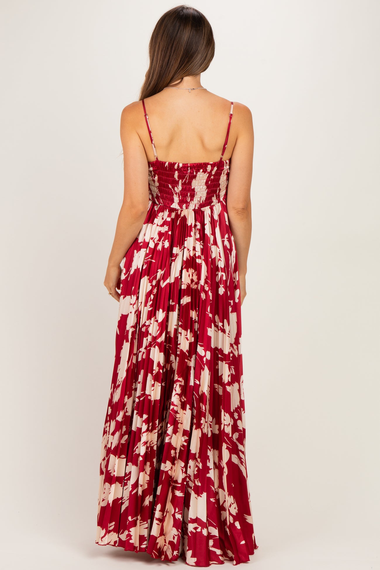 woman wearing a red floral print maternity maxi dress with smocked back and adjustable straps