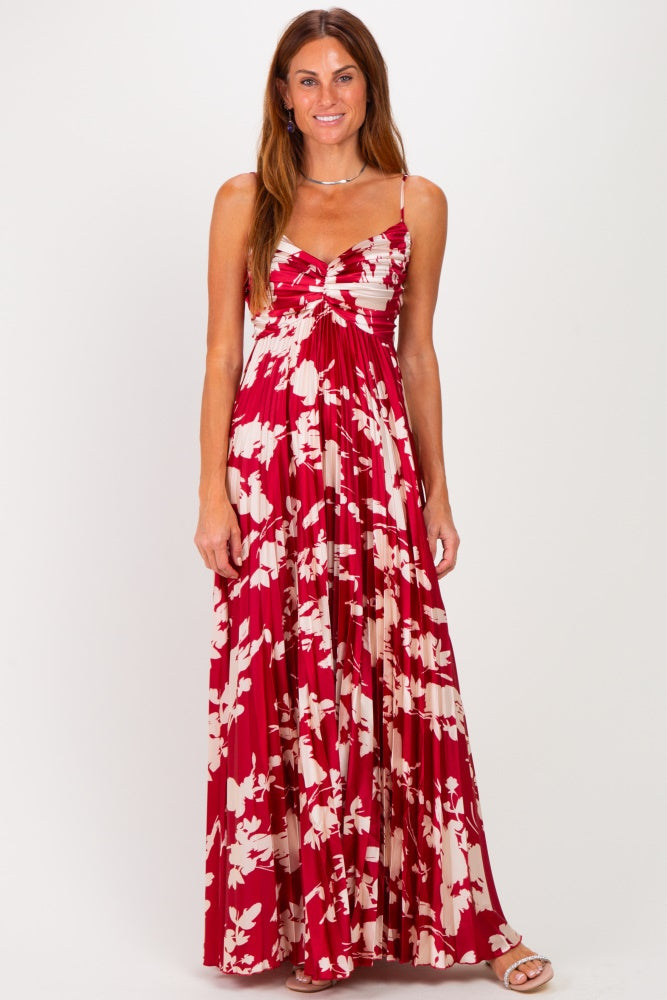 woman wearing a red and white floral maxi dress with adjustable straps and a gathered bust detail