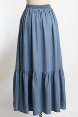 blue denim maxi skirt with a tiered ruffle detail and an elastic waist