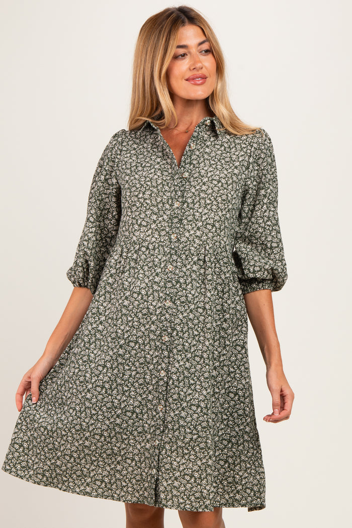 woman wearing a green floral maternity dress with a button-down front and puffed sleeves