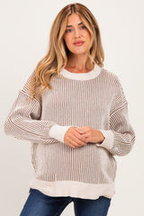 woman wearing a light beige striped knit maternity sweater with a relaxed fit and long sleeves