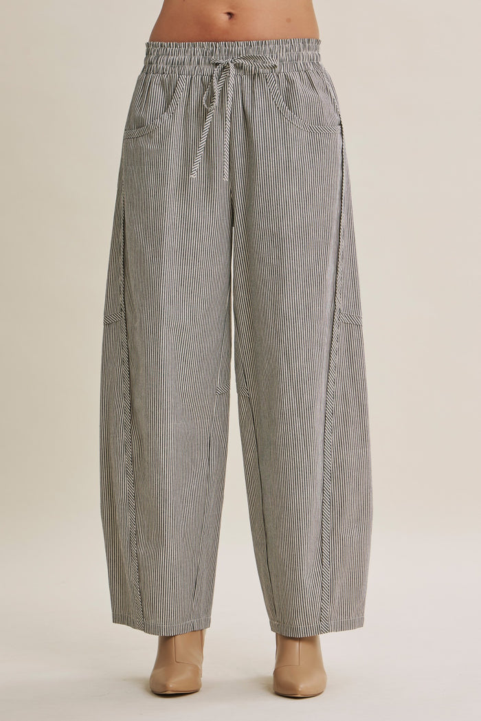 woman wearing black and white striped wide-leg pants with an elastic waistband and side pockets