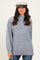 woman wearing a light gray oversized sweater with a high neckline and long sleeves, paired with a stylish cap