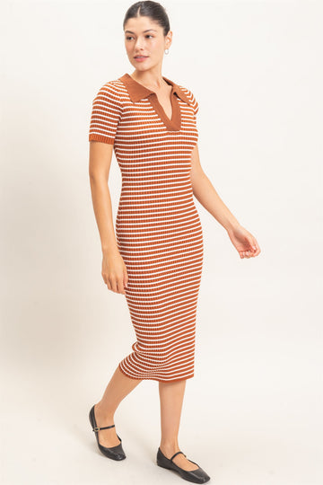 woman wearing a striped midi dress in warm hues of orange and brown with a polo-style collar and short sleeves