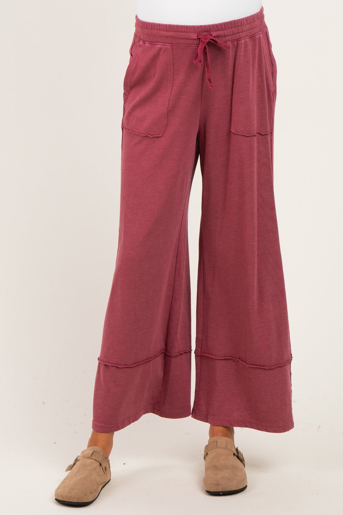 woman wearing a raspberry wide-leg maternity pants with pockets and a comfy elastic waistband