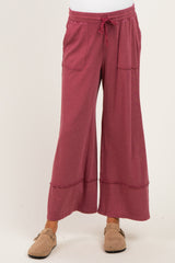 woman wearing a raspberry wide-leg maternity pants with pockets and a comfy elastic waistband
