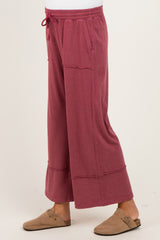 maternity wear loose-fitting burgundy wide-leg pants with an elastic waistband and side pockets