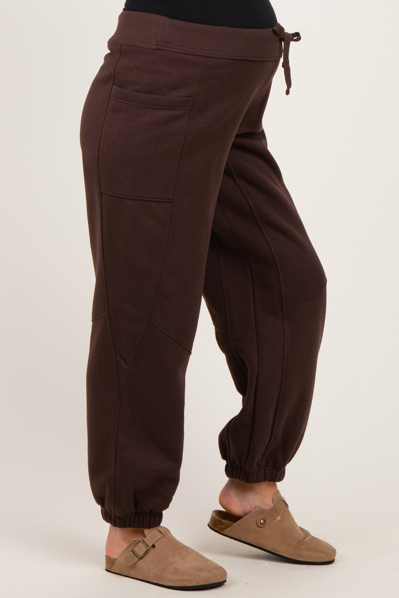 woman wearing brown maternity jogger pants with side pockets and elastic cuffs