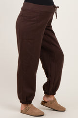woman wearing brown maternity jogger pants with side pockets and elastic cuffs