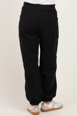 woman wearing black maternity jogger pants with pockets and elastic cuffs, viewed from the back
