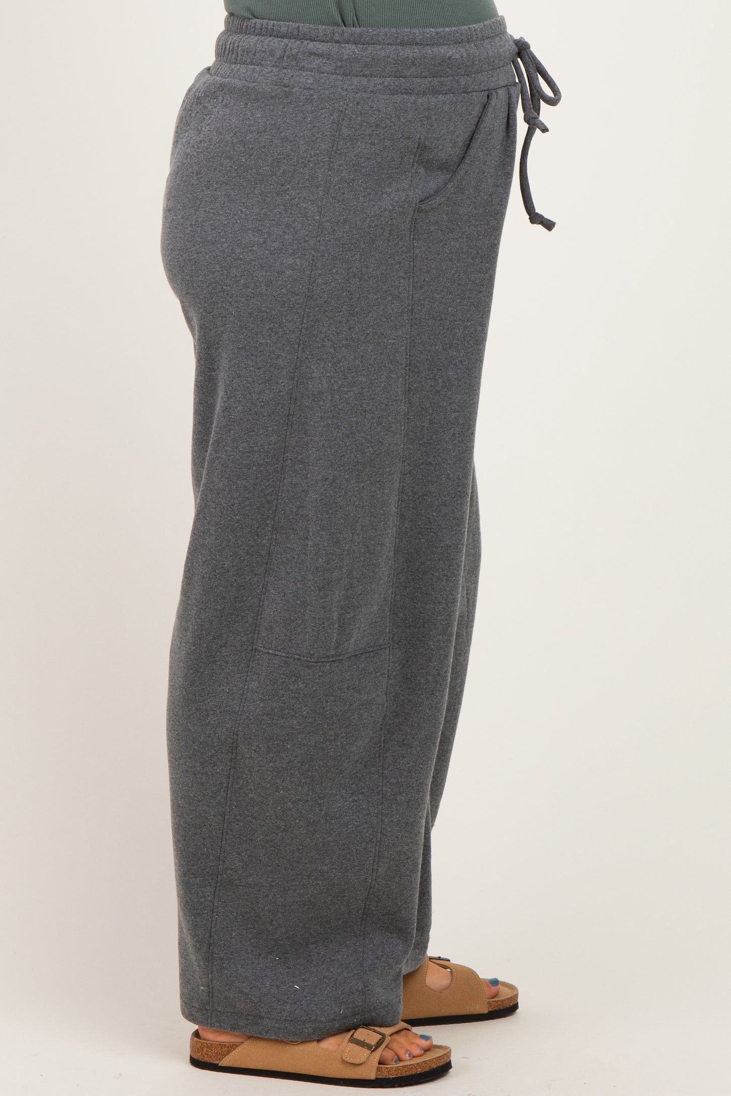 woman wearing gray maternity sweatpants with side pockets and an elastic waistband