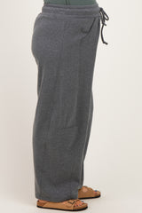 woman wearing gray maternity sweatpants with side pockets and an elastic waistband
