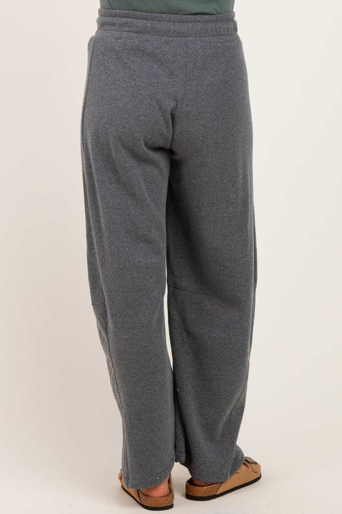 woman wearing gray maternity sweatpants, view of the back, relaxed fit and elastic waistband