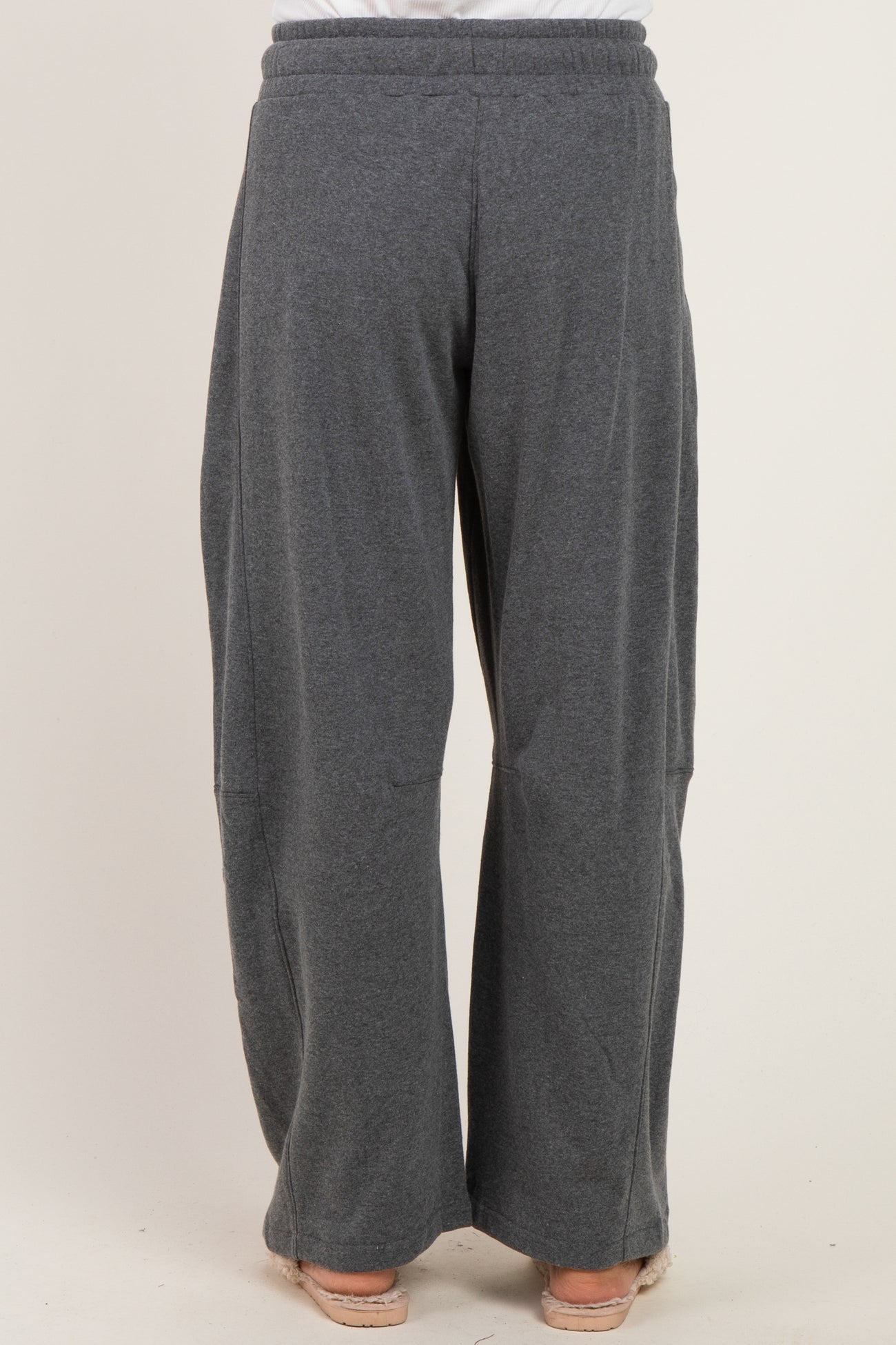 woman wearing gray wide-leg lounge pants with an elastic waistband, viewed from the back