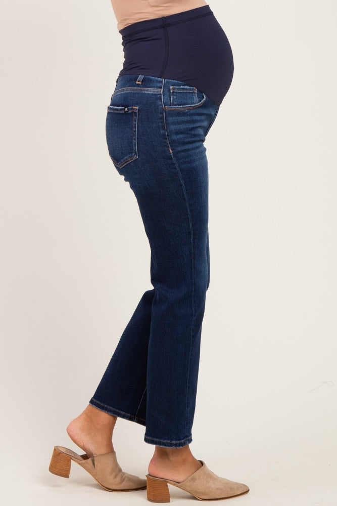 woman wearing dark blue maternity jeans with a supportive belly panel and a visible baby bump