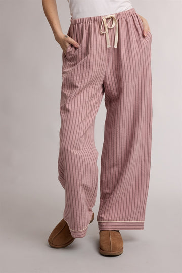 woman wearing pink striped lounge pants with an elastic waistband and drawstring, features side pockets