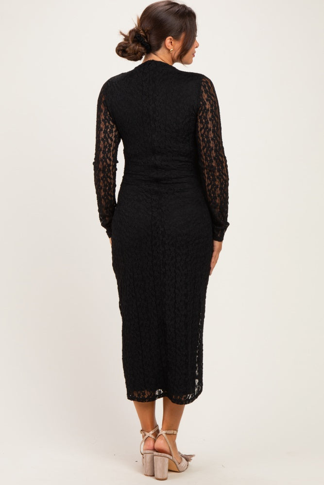 woman wearing a black lace maternity dress with long sleeves and a fitted silhouette, viewed from the back