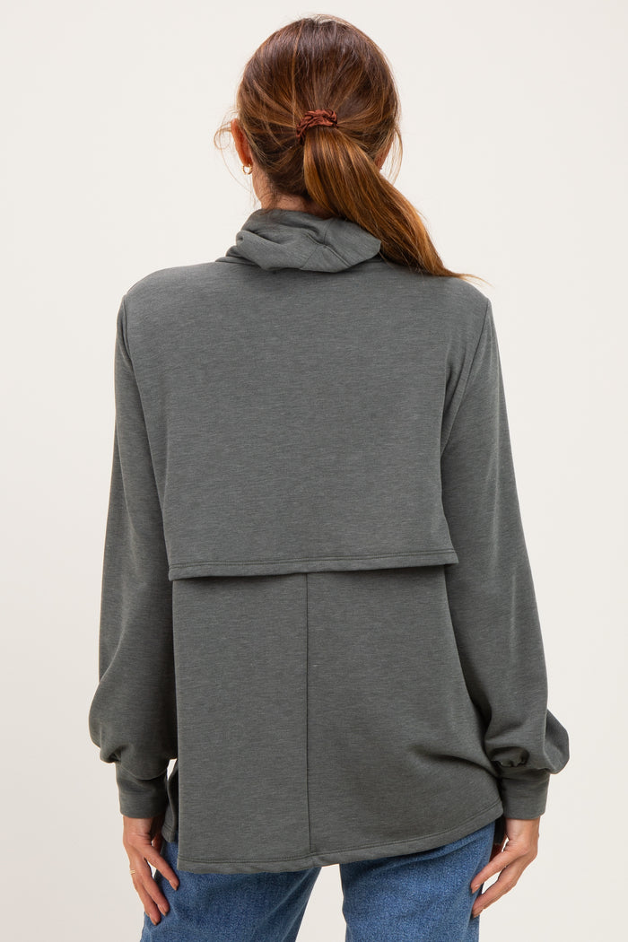 woman wearing a gray long sleeve hoodie with a layered design and a relaxed fit, viewed from the back