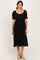 woman wearing a black midi dress with puff sleeves and button details in the front