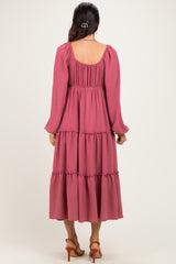 woman wearing a dusty rose long sleeve tiered maxi dress with a square neckline and ruffle detailing